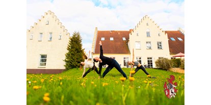 Hundehotel - Umgebungsschwerpunkt: See - Groß Mohrdorf - Entspannen Sie bei einem vor Ort geführten Yogakurs im Garten. - Hotel Gut Tribbevitz 