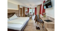Hundehotel - Saalbach - Modern und im Landhausstil eingerichtete Doppel / Familienzimmer
laden zum ausschlafen ein - Berghotel Jaga Alm 