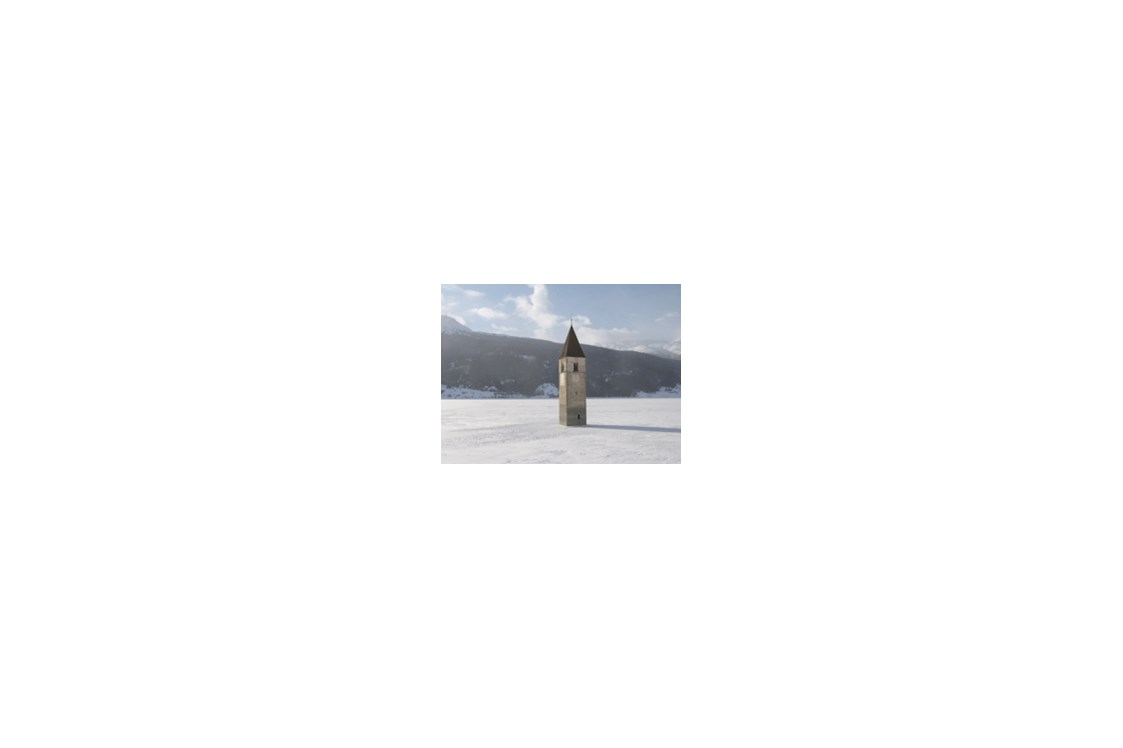 Urlaub-mit-Hund: Kirchturm im gefrorenen Reschensee - Hotel Reschnerhof