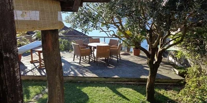 Hundehotel - Unterkunftsart: Einzelhaus - Sitzplatz und Liegeplatz unter dem Olivenbaum - Casa Fiore - Ferien am Lago Maggiore